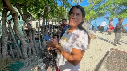 Diana Mahalebu shows the application that she uses for recording her seaweed production.