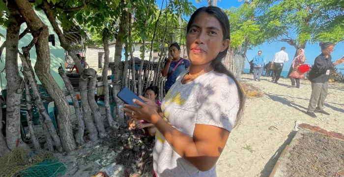 Diana Mahalebu shows the application that she uses for recording her seaweed production.