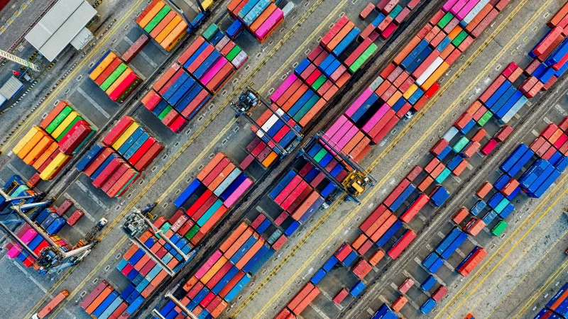 A harbour with containers, photographed from above.